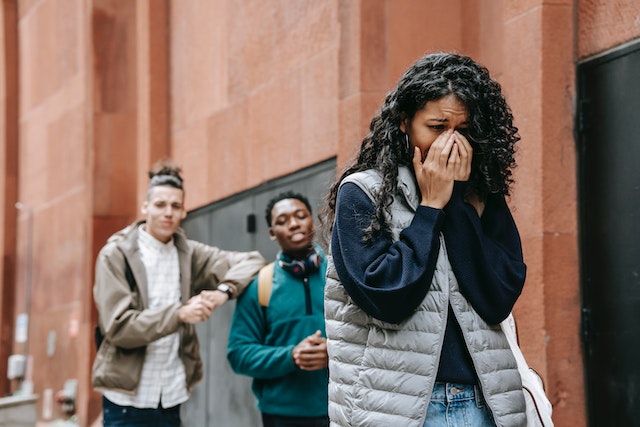 girl walking away from men
