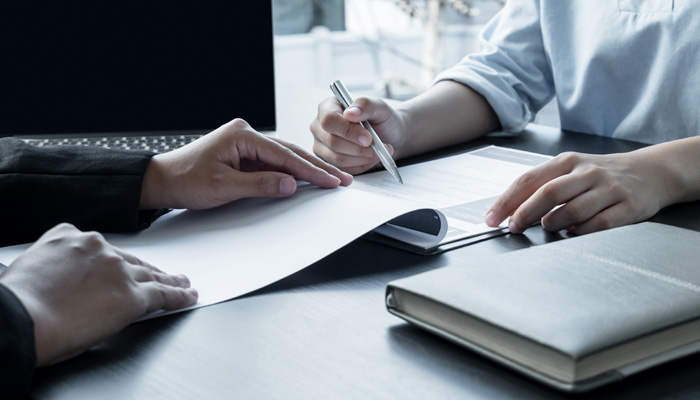 business people hold a resume and talk to job applicants for job interviews about careers and her personal history in the company