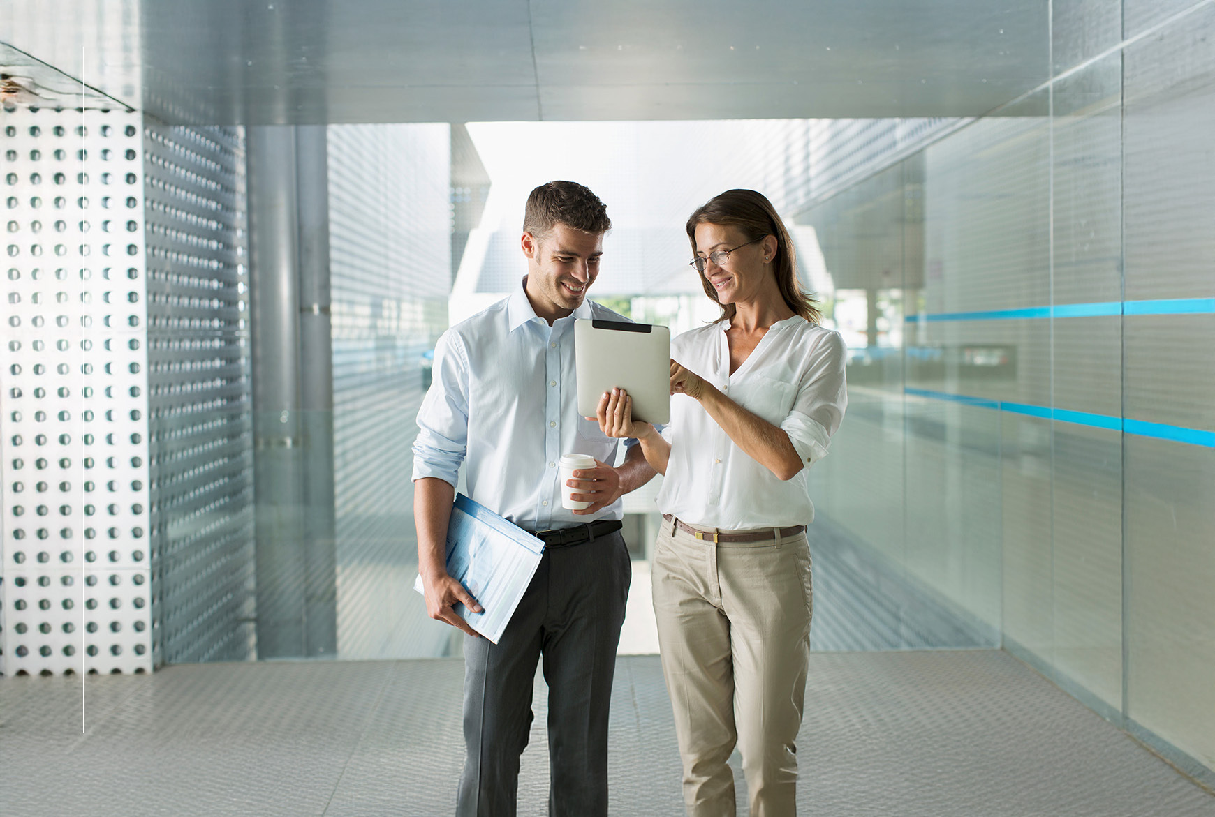 two business people using a digital tablet in a modern office