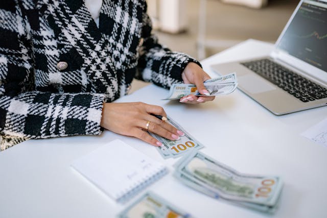 person sorting bills with calculator