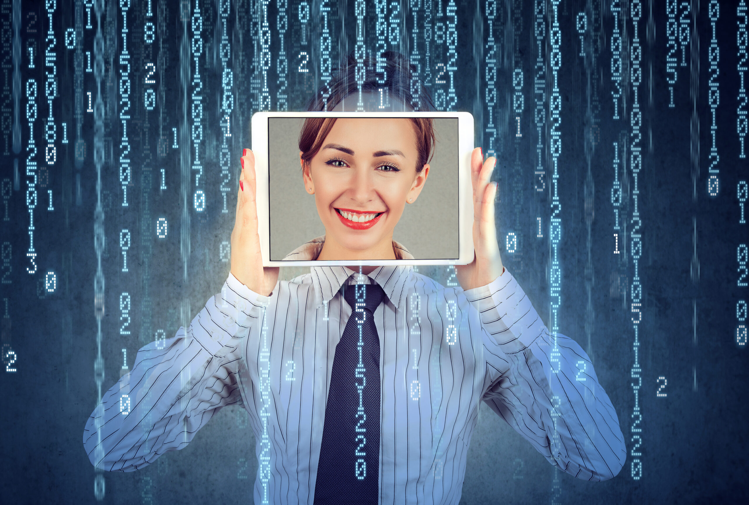Happy woman holding tablet with her face displayed on a screen isolated on binary code background